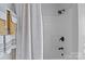 Bright bathroom features a shower with sleek black fixtures and a patterned shower curtain at 1002 4Th Ne St, Conover, NC 28613