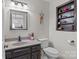Neutral half-bath with granite sink and decorative shelving provides convenience for guests at 1002 4Th Ne St, Conover, NC 28613