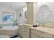 Bright bathroom with dual vanities, tile backsplash, round mirrors, and separate soaking tub at 1002 4Th Ne St, Conover, NC 28613