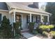 Inviting porch featuring a wreath, a seating area, and traditional architectural details with a landscaped yard at 1002 4Th Ne St, Conover, NC 28613