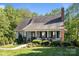 Traditional single-story home with a welcoming front porch, a well-kept lawn, and mature trees at 1002 4Th Ne St, Conover, NC 28613