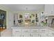 Bright eat-in kitchen with granite counters, white cabinets and view to dining and living areas at 1002 4Th Ne St, Conover, NC 28613