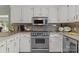 Well-lit kitchen features white cabinets, stainless steel appliances, and granite countertops at 1002 4Th Ne St, Conover, NC 28613