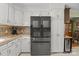 Bright kitchen featuring a black refrigerator, white cabinets, and granite countertops at 1002 4Th Ne St, Conover, NC 28613