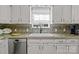 Bright kitchen featuring a white farmhouse sink, white cabinets, and granite countertops at 1002 4Th Ne St, Conover, NC 28613