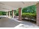 Covered patio area with brick columns, offering a view of the landscaped backyard at 1002 4Th Ne St, Conover, NC 28613