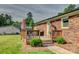 Outdoor deck with grill and furniture, attached to brick house and bordered by lawn at 1009 High Shoals Rd, Lincolnton, NC 28092