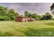 Spacious backyard with a large lawn, a wooden deck, and mature trees at 1009 High Shoals Rd, Lincolnton, NC 28092