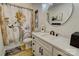 Well-lit bathroom with white vanity, patterned shower curtain, and a round mirror at 1009 High Shoals Rd, Lincolnton, NC 28092