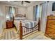 Comfortable bedroom with an iron bed frame, wood floors, and light-filtering curtains at 1009 High Shoals Rd, Lincolnton, NC 28092