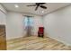 Minimalist bedroom features wood floors, an antique dresser, a patterned curtain, and a rocking chair at 1009 High Shoals Rd, Lincolnton, NC 28092