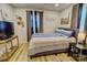 Comfortable bedroom featuring a striped comforter set, wood flooring, and natural light at 1009 High Shoals Rd, Lincolnton, NC 28092