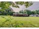 Charming brick ranch home with a large, well-maintained lawn and mature trees providing shade at 1009 High Shoals Rd, Lincolnton, NC 28092