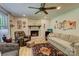 Comfortable living room features a brick fireplace, ceiling fan, and stylish decor at 1009 High Shoals Rd, Lincolnton, NC 28092