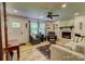 Cozy living room features a brick fireplace, ceiling fan, and ample natural light at 1009 High Shoals Rd, Lincolnton, NC 28092