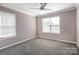 Bedroom with two windows providing ample natural light, ceiling fan and carpet flooring at 10146 Hawkeye Dr # 2, Charlotte, NC 28273