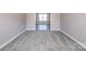 Neutral bedroom featuring soft carpet, base trim, and ample space at 10146 Hawkeye Dr # 2, Charlotte, NC 28273