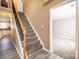 Inviting entryway with staircase, wood floors, and doorway leading to a carpeted room at 10146 Hawkeye Dr # 2, Charlotte, NC 28273