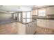 Open concept kitchen with island, tile floors, granite countertops, white cabinetry, and stainless steel appliances at 10146 Hawkeye Dr # 2, Charlotte, NC 28273