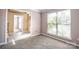 Bright living room with carpet, large window offering natural light and view into an adjoining space at 10146 Hawkeye Dr # 2, Charlotte, NC 28273