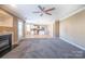 Spacious living room featuring carpeted floors, a fireplace, and a ceiling fan at 10146 Hawkeye Dr # 2, Charlotte, NC 28273