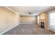 Large living room with soft carpet, fireplace, ceiling fan and lots of space at 10146 Hawkeye Dr # 2, Charlotte, NC 28273