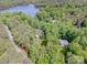 Expansive aerial view of a wooded property near the lake showcasing the natural beauty and secluded setting at 112 Eagle Chase Ln, Troutman, NC 28166