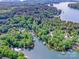 Breathtaking aerial shot of lakefront homes nestled among lush greenery, highlighting the private boat docks at 112 Eagle Chase Ln, Troutman, NC 28166