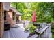 An expansive back deck features outdoor seating, a grill, and a peaceful view of the wooded backyard at 112 Eagle Chase Ln, Troutman, NC 28166