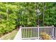 A back deck overlooks lush greenery, offering a serene spot to relax and enjoy the surrounding natural beauty at 112 Eagle Chase Ln, Troutman, NC 28166