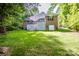 An expansive brick home features a two-story deck and luscious green yard at 112 Eagle Chase Ln, Troutman, NC 28166