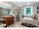 Bathroom featuring a soaking tub, stained glass window, granite counter tops, and a glass-enclosed shower at 112 Eagle Chase Ln, Troutman, NC 28166