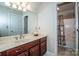 Bathroom with marble counter tops, cherry wood cabinetry, and bathtub with shower at 112 Eagle Chase Ln, Troutman, NC 28166