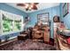 Bedroom with traditional desk, leather chair and ottoman, wood floors, and lots of natural light at 112 Eagle Chase Ln, Troutman, NC 28166