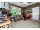 Cozy bonus room with a floral loveseat, red chair, and natural light from the large window at 112 Eagle Chase Ln, Troutman, NC 28166
