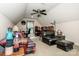 Large bonus room featuring an vaulted ceiling, comfortable leather seating, and natural light from a window at 112 Eagle Chase Ln, Troutman, NC 28166