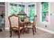 Cozy eat-in kitchen nook with stained glass windows offering scenic views and a cozy atmosphere at 112 Eagle Chase Ln, Troutman, NC 28166