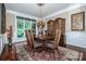 Elegant dining room with a large window, wood floors, and plenty of space for entertaining at 112 Eagle Chase Ln, Troutman, NC 28166