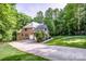 Rear exterior view of brick home with a two-car garage and large driveway at 112 Eagle Chase Ln, Troutman, NC 28166