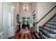 Inviting foyer with hardwood floors, a grand staircase, and stained-glass front door at 112 Eagle Chase Ln, Troutman, NC 28166