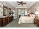 Serene main bedroom features trey ceiling, floral wallpaper, and arched windows with natural light at 112 Eagle Chase Ln, Troutman, NC 28166