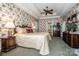 A bedroom featuring floral wallpaper, trey ceiling, ceiling fan, and a bed with a decorative headboard at 112 Eagle Chase Ln, Troutman, NC 28166