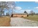Back exterior view of a one story brick house with a gravel driveway at 1177 Craigbrow Cir, Chester, SC 29706
