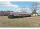 A view of the property showing the brickwork, shutters, and tree-lined yard, lending a quiet, suburban charm at 1177 Craigbrow Cir, Chester, SC 29706