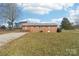 Back exterior view of a one story brick house with a large backyard at 1177 Craigbrow Cir, Chester, SC 29706