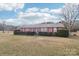 Well-kept single story brick home with manicured bushes, complemented by a green lawn and striking purple shutters at 1177 Craigbrow Cir, Chester, SC 29706