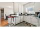 Well-lit kitchen offering white cabinetry, a bar counter for seating, and a view into the adjacent dining area at 1177 Craigbrow Cir, Chester, SC 29706
