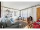 Bright living room with a cozy sofa, large window, decorative wallpaper border, and a stylish display shelf at 1177 Craigbrow Cir, Chester, SC 29706