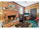 Living room featuring brick fireplace and wood paneling at 1177 Craigbrow Cir, Chester, SC 29706