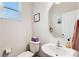 Clean half bathroom featuring a toilet, sink, mirror, and small storage shelf at 1206 Keydet Dr, Charlotte, NC 28216